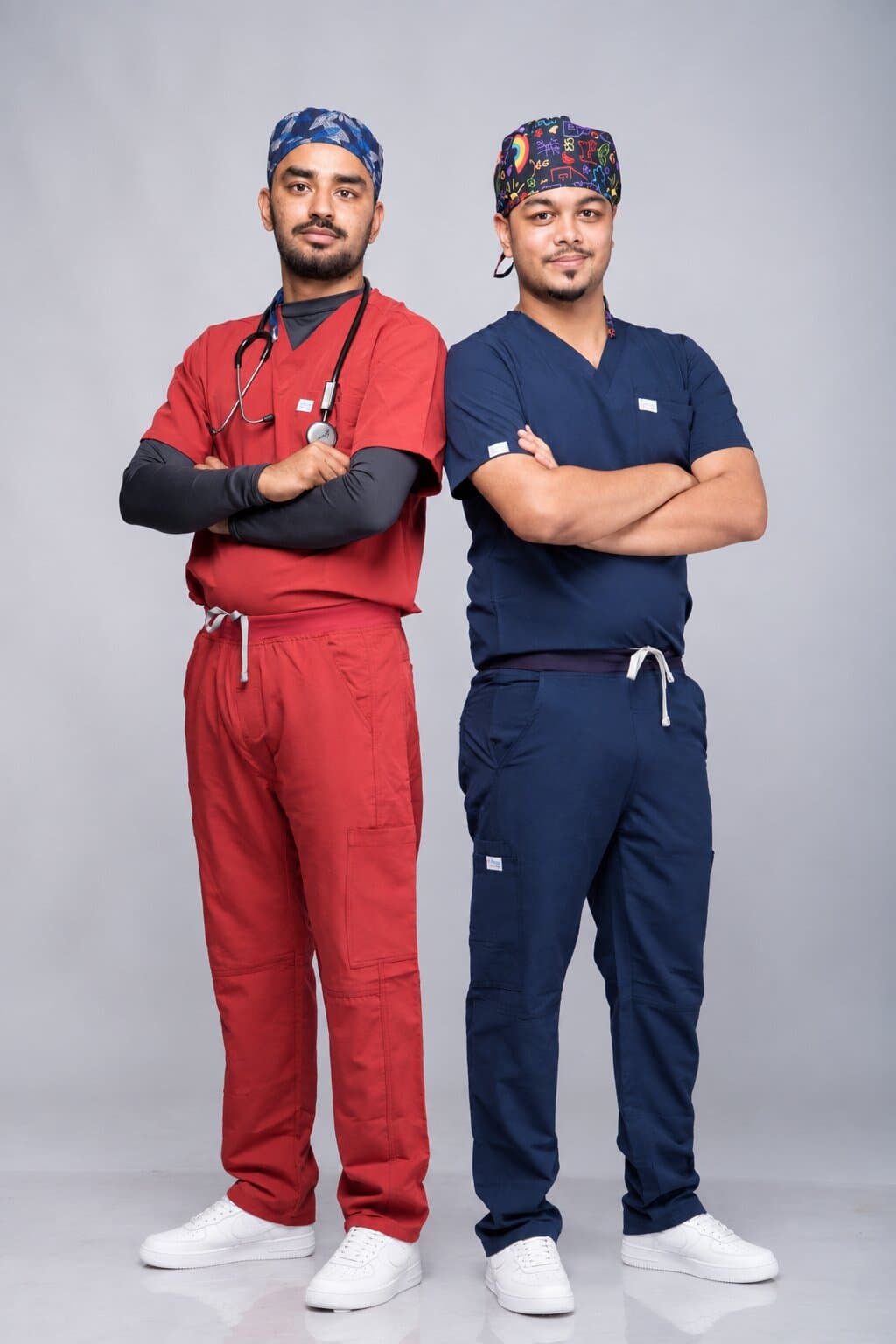 Two doctors in wine red and navy Medisewa scrubs