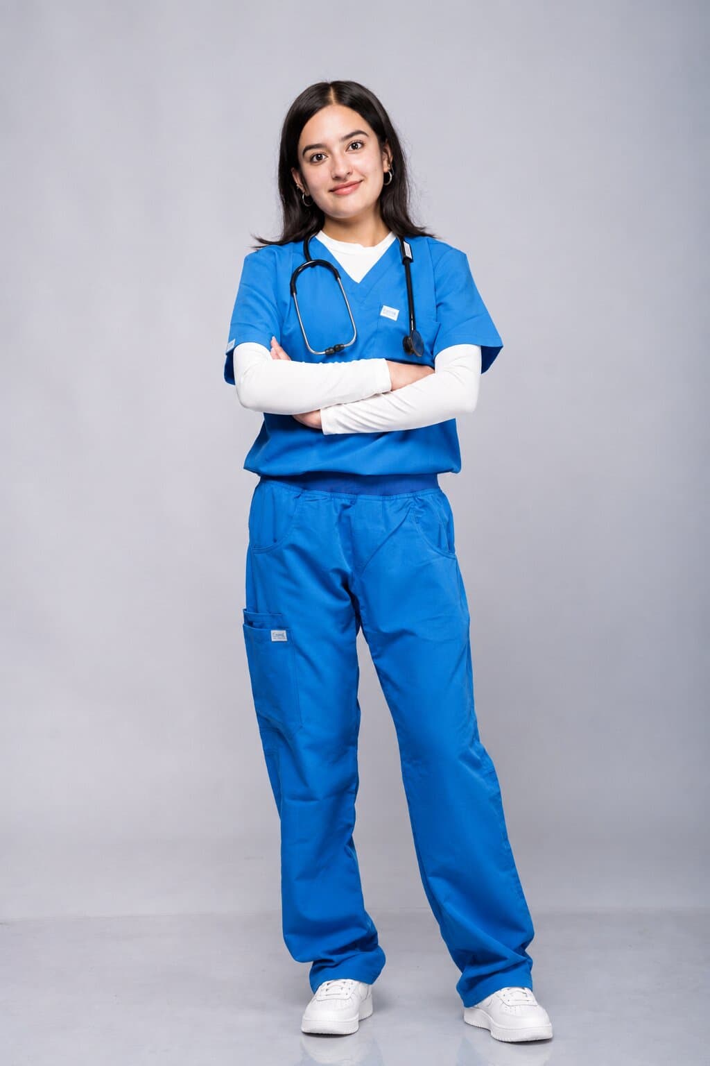Doctor in a royal blue Medisewa scrub set with a stethoscope